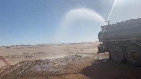 Sprinkler gun system used to mitigate dust suppression