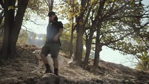 A man walking with his dog in a forest