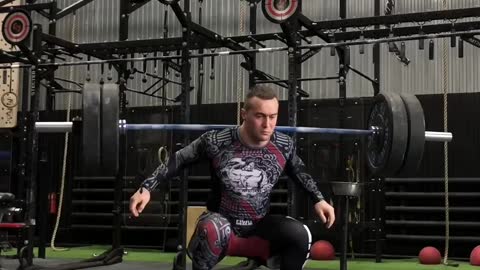 Man Lifts Weights While on Balance Board