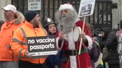 Protesters gather in front of Parliament chanting 'Arrest Boris Johnson.' [mirrored]