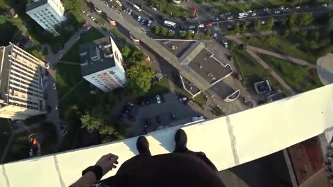 Parkour runner misses his jump and falls off a high rise rooftop