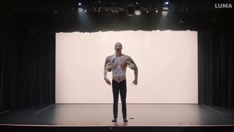 Man starts to turn into a white zebra on a stage