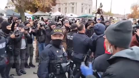 Police arrest two BLM supporters outside the courthouse of the Rittenhouse trial