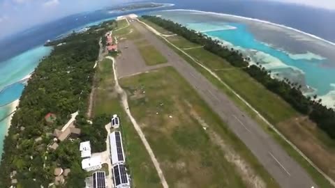 Wingsuit flying over the Maldives island