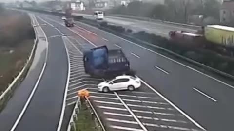 car stops on highway to not miss exit and causes trucks to lose control.