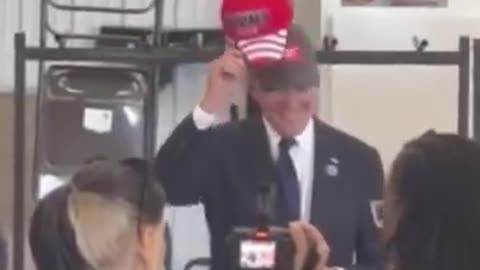 Joseph Martelli Joe Biden put on a Donald Trump hat