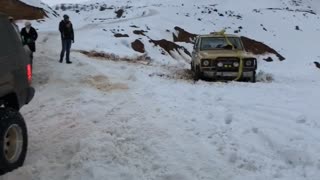 Truck tries to pull stuck car out of ditch with ratchet tie, tie snaps