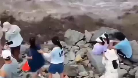 People trying to record the Qiantang River in China on video were swept away