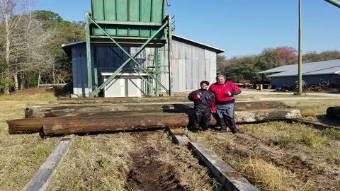 Using a Crane to pull 200 - 500-Years-Old River-Recovered® Heart Pine Logs From Our Millpond