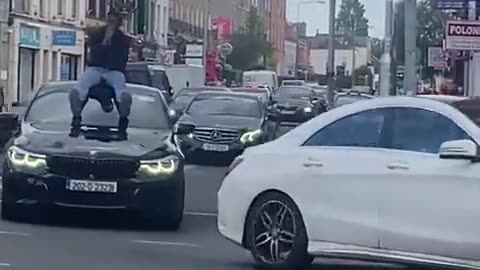 Rathmines area of Dublin, African jumps onto a random persons car and refuses to get off...