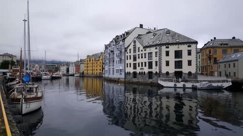 harbour with boats and colorful houses in alesund norway