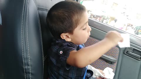 1 years baby acting like very hot in car Showing expression with tissue