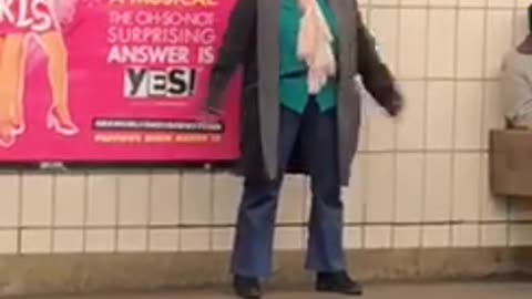 Woman waiting for subway clapping above head