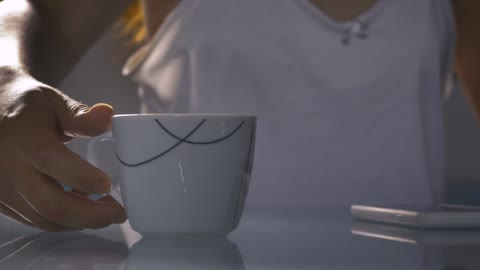 Cup with hot morning coffee in the foreground