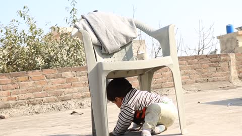 Kid stuck under the chair put strategy to come out from it and celebrate the victory at the end