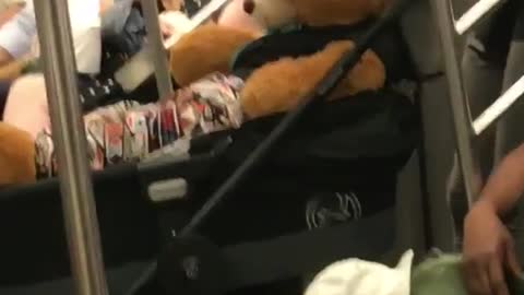 Giant teddy bear inside of a stroller