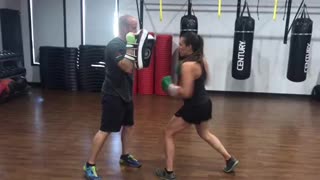 Pad work in kickboxing class