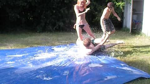 Teen Takes Out Girl On Slip-N-Slide