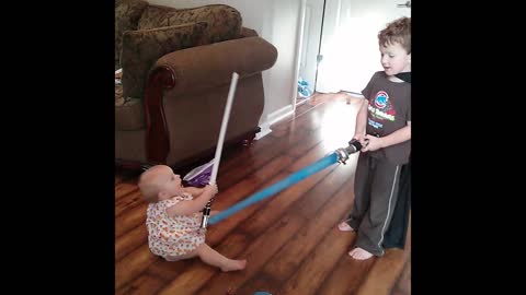 Brother versus baby lightsaber duel