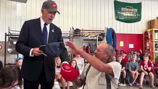 Biden’s Trump hat gesture win cheers from crowd