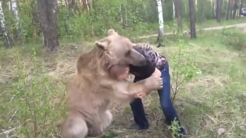 Russian guy plays with bear