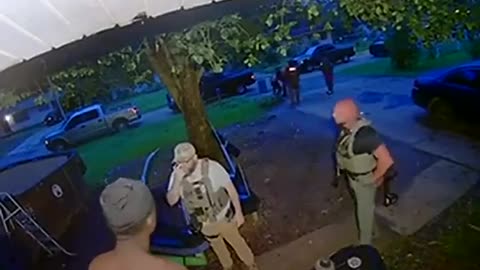 Cop strikes handcuffed subject.