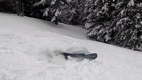 Guy Crashes Into Snow While Landing A Slip And Flip Trick On The Snowboard