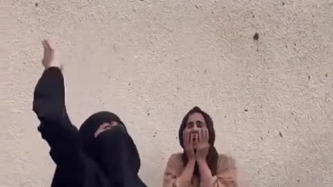 Palestinians cry in pain over their sister, who was killed by Israeli occupation airstrike