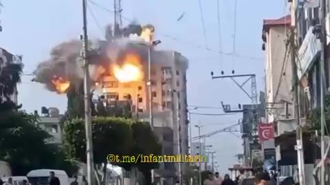 A guided aerial bomb strikes a residential apartment building in Gaza.