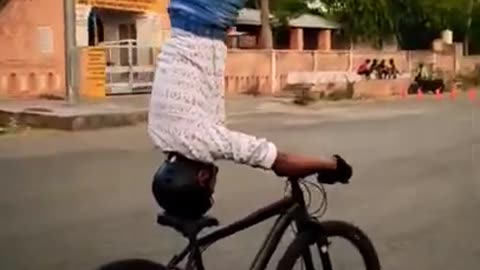 Headstand on moving cycle