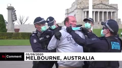 Supposedly in Australia, police force mask on man who is handcuffed