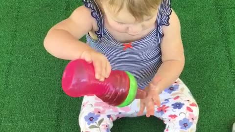 Cute toddler "washes" her hair with sweet tea!