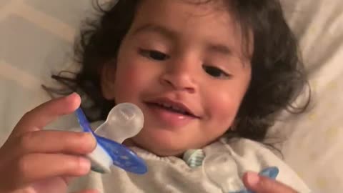 Adorable toddler has fun sucking on two pacifiers at a time! So funny!!