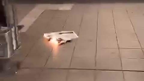 Newspaper on fire man puts it out