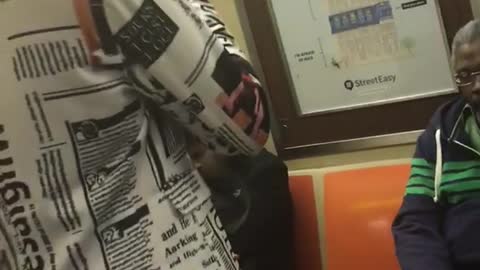 Guy suit newspaper dancing subway earphones