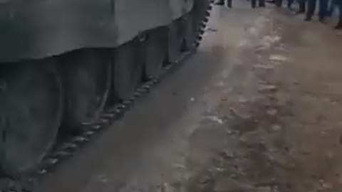 Unarmed civilians and Ukrainian police barring the advance of a Russian armored column into Ukraine.