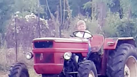 Kid riding tractor