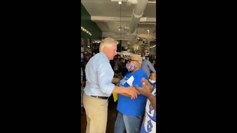 Virginia Democrat Terry McAuliffe enters a packed restaurant without a mask, hugs people.