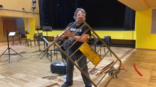 Spanish Musician Xavier Lozano Playing a Flute Made From a Street Barricade.