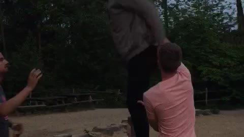 Guy in grey sweater backflips off pole and lands on his face