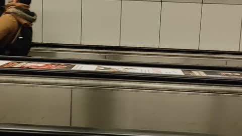 Tilted Escalator Riders in Budapest