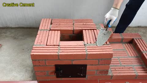 Outdoor wood stove from red brick and cement