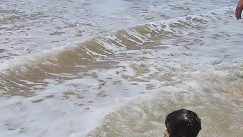 Waves Sweep This Baby Off His Feet