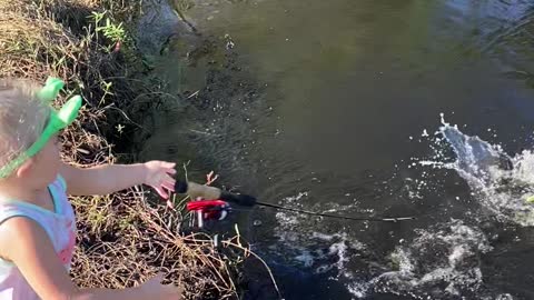 Daughter Reeling in First Fish Drops Pole