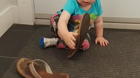 Baby girl trying sandals for the first time