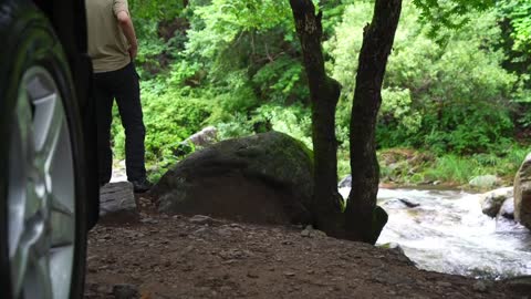 Light self driving camping in summer, listening to the sound of water flow at the river valley, enjo