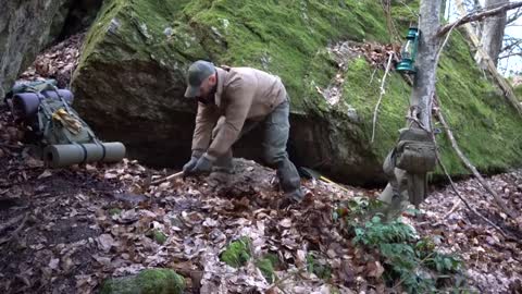 Four excavated shelter.Building underground bunker.Earth hut. primitive technology.Clay stone oven-3