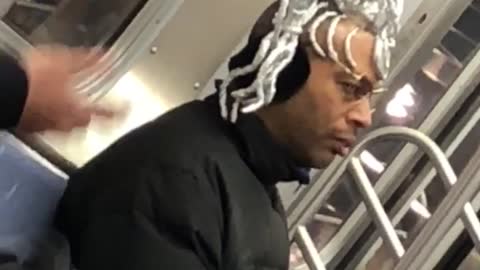 Man on subway with silver tinfoil hair