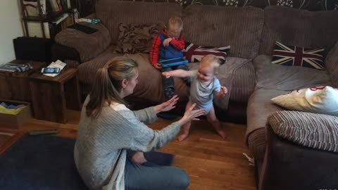 Baby takes his first steps and then applauds himself