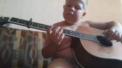 A Russian boy plays the guitar